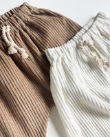 Detailansicht der Cordhose für Babys und Kleinkinder mit aufgesetztem Bündchen in off white und warm sand.